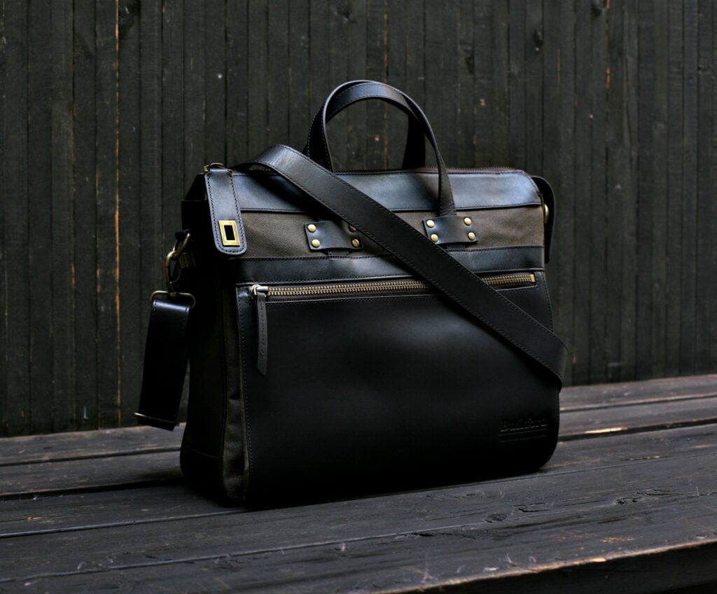 Front view of Builford 628 Portfolio briefcase featuring premium black leather and tan waxed canvas